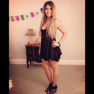 Crocheted black lace up back romper. Size Medium.